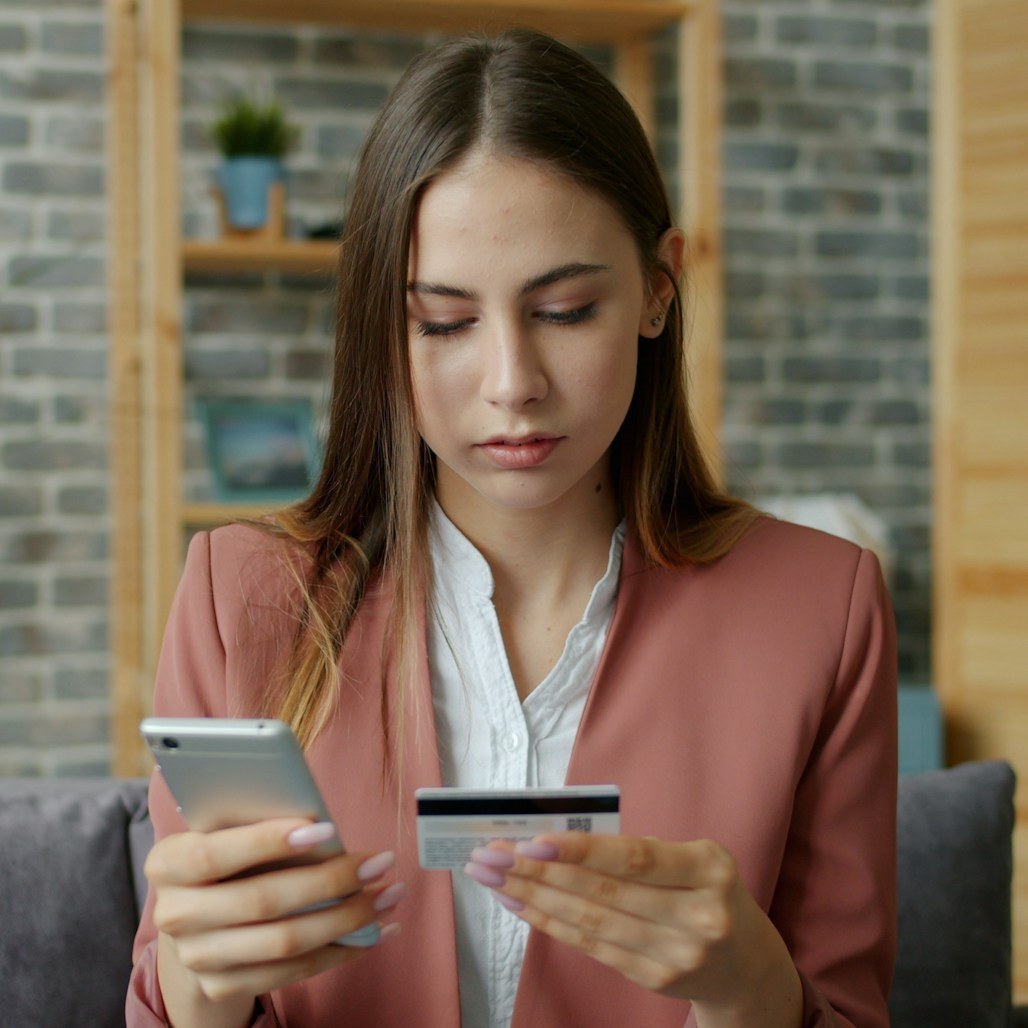 Woman checking her card on her phone